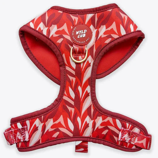 Red and pink adjustable dog harness with leafy pattern and metal D-ring, white background